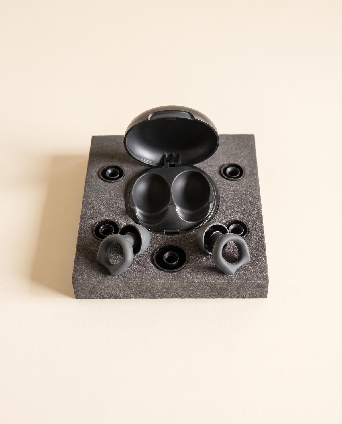 DAYBLIND silicone earplugs with case and five tip sizes on a cream background